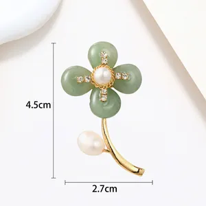 Detailed close-up of a floral pearl brooch with green petals and gold finish, size 4.5x2.7cm