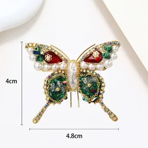 Detail of butterfly brooch showing baroque pearls and green crystals with 4.8cm width