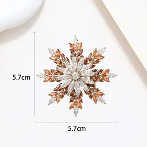 Detailed macro view showing the 5.7cm rotating snowflake brooch with colorful zircons