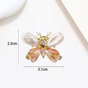 Detailed macro shot of butterfly pearl brooch showing 2.3cm by 3.1cm dimensions