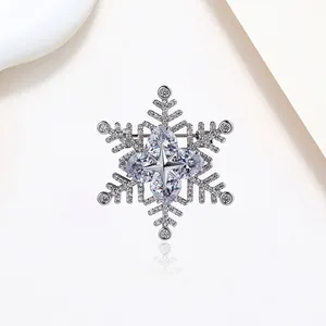 Elegant rotating silver snowflake brooch with sparkling crystals and zirconia stones