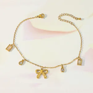 Detail of gold butterfly anklet with sparkling zircon teardrop and rectangular charms