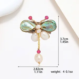 Macro detail of handmade butterfly pearl brooch with dimensions and weight specs