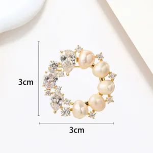 Detailed view of 3cm round pearl wreath brooch with crystals on gold-plated metal base