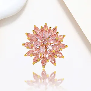 Macro shot of pink marquise-cut stones and gold claw-set finish on flower brooch