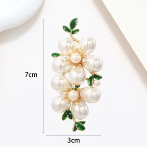 Detail view of floral pearl brooch showing 7cm height and 3cm width measurements