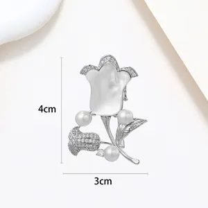 Detailed view of tulip brooch with white pearls and shell petals, dimensions 4cm x 3cm