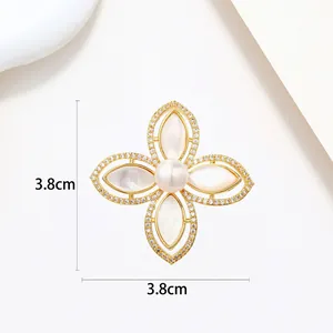 Macro shot of 3.8cm gold floral brooch with pearl center and white mother-of-pearl leaves