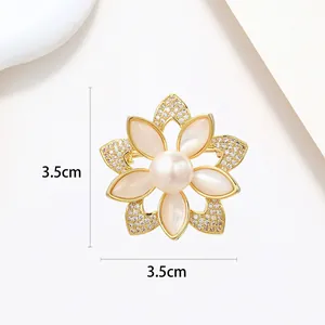 Detail view of flower brooch with white pearl and opal petals measuring 3.5cm x 3.5cm
