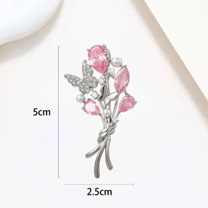 Detailed view of butterfly pearl brooch with pink gems, measuring 5cm by 2.5cm size