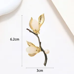 Macro detail of elegant floral pearl brooch with gold leaf and 6.2cm size markings