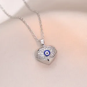 Gros plan du collier cœur œil protecteur avec pavé étincelant sur soie rose douce