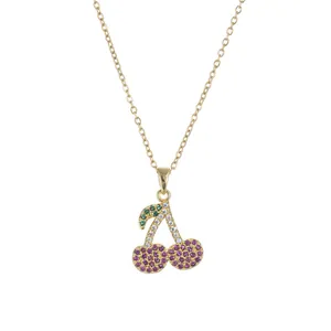 Elegant gold chain necklace featuring a cherry pendant with purple and green crystals