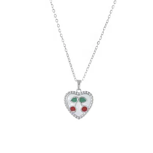 Silver chain necklace featuring a white heart pendant with red cherry enamel detail
