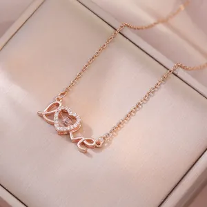 Rose gold LOVE heart pendant necklace with shimmering cubic zirconia on champagne silk
