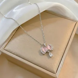 Elegant butterfly pendant necklace with pink opal and rhinestones on silk background