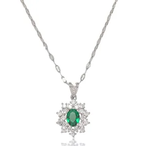 Elegant emerald green gemstone snowflake necklace with silver chain on white background