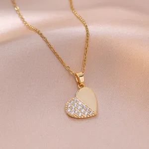 Elegant gold heart pendant necklace featuring sparkling pave zircon stones on satin background
