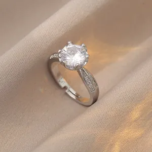 Close-up of a silver adjustable ring featuring a six-prong set round zircon and side diamonds