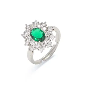 Elegant silver ring with oval emerald-green stone and double halo of crystals