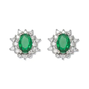 Detailed view of silver oval emerald stud earrings surrounded by white crystals