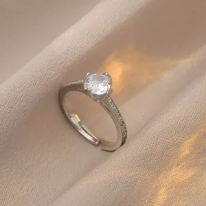 Detail of elegant silver ring featuring 1 carat round diamond and sparkling micro-pave accents