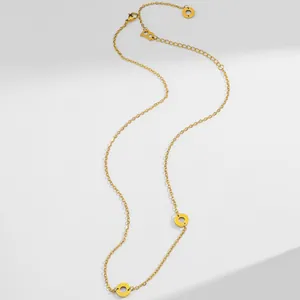 Detail of 18K gold stainless steel chain with round Beauty charms and lobster clasp