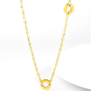 Close-up of 18K gold plated stainless steel chain with dual circle engraved pendants
