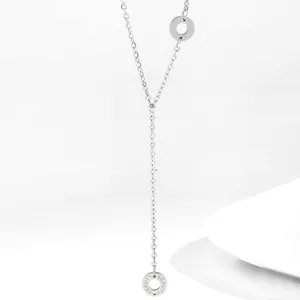 Close-up of silver 18K stainless steel Y-shaped necklace with Beauty engraved rings