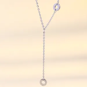 Detail of silver Y-shaped necklace featuring engraved BEAUTY hollow circle pendants