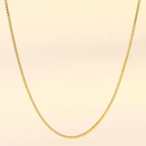Detail of 18K gold-plated stainless steel box chain necklace with smooth glossy finish
