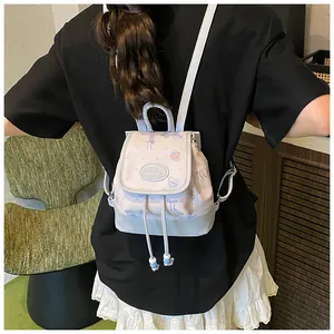 Rear view of a mini floral bucket backpack with drawstring and blue bead details