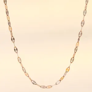 Detailed view of an 18K gold-plated stainless steel cross chain with flat oval links