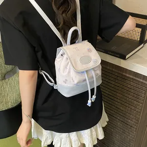 Floral bucket backpack with bear patterns and blue contrast panels for daily use