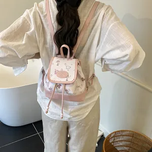 Mini floral drawstring bucket backpack in white and pink leather for women