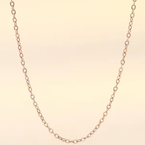 Vertical detail of 18K rose gold-plated stainless steel cross chain with a lobster clasp