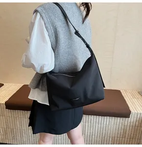 Casual black nylon crossbody bag with adjustable strap and large capacity for daily commute