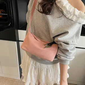 Pink suede minimalist underarm bag with silver heart pendant and stylish leather fringe