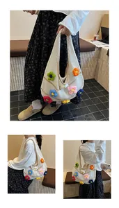 Detail of white crochet hobo bag featuring multi-colored 3D floral knitted decorations