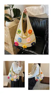 Detailed macro view of white hand-woven tote bag with colorful crochet flower patterns