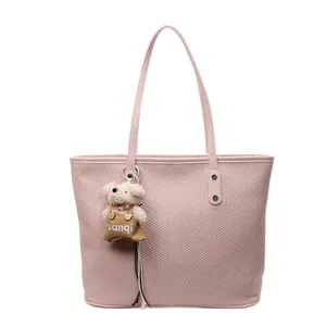 Pink minimalist tote bag with twill texture and cute plush bear charm for daily use