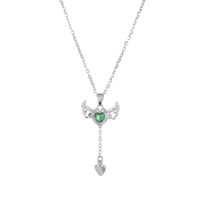 Silver necklace with a green heart stone and angel wings pendant with a small charm