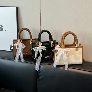 Three elegant vintage square handbags in dark brown, black, and white with woven handles