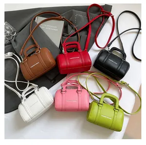 Flat lay showing six colors of mini lychee pattern leather Boston bags with straps