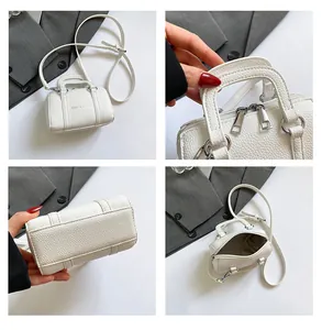 Close-up details of white litchi pattern Boston bag with silver zippers and handles
