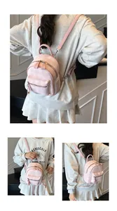 Detail of pink plaid mini backpack featuring dual zippers and adjustable straps