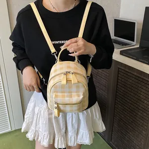 Mini yellow and white plaid backpack with rabbit ears in a stylish preppy college style