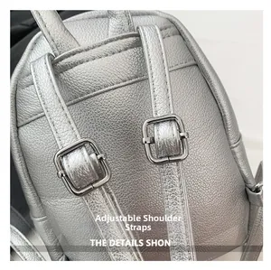 Detail of adjustable shoulder straps on silver textured faux leather backpack