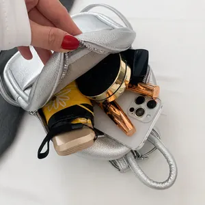 Capacity display showing phone, lipstick and umbrella inside the silver egg-shaped bag
