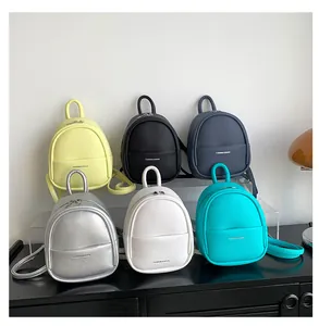 Mini egg-shaped backpacks in six vibrant colors with lychee pattern faux leather texture